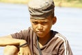 Photo of adorable young happy boy - african poor child on the ri Royalty Free Stock Photo