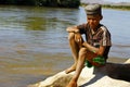 Photo of adorable young happy boy - african poor child on the ri Royalty Free Stock Photo