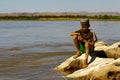 Photo of adorable young happy boy - african poor child on the ri Royalty Free Stock Photo