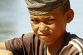 Photo of adorable young happy boy - african poor child on the ri Royalty Free Stock Photo