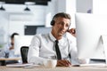 Photo of adult man 30s wearing office clothes and headphones, si Royalty Free Stock Photo