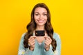 Photo advert of young cheerful lady promoter hold black premium plastic card demonstrate wireless nfc option isolated on