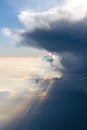 Aerial view from airplane of rain clouds and blue sky in twilight