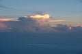 Aerial view from airplane of rain clouds and blue sky in twilight