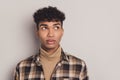 Photo of african guy curious look empty space think wear checkered shirt rollneck isolated grey color background