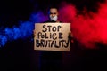 Photo of afro american guy hold paper card banner stop police brutality suffer speechless voiceless silence adhesive Royalty Free Stock Photo