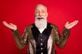 Photo of aged show man happy positive smile hold hands magician illusionist concert isolated over red color background