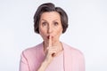 Photo of aged woman cover lips finger shh keep secret confidential isolated over grey color background Royalty Free Stock Photo