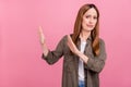 Photo of aged woman negative dislike gesture hands stop symbol refuse ban isolated over pink color background