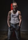 Photo of aggressive athlete and red boxing bag Royalty Free Stock Photo