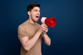 Photo of aggressive mad man wear trendy beige clothes hold bullhorn shout scream look empty space isolated on dark blue Royalty Free Stock Photo