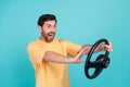 Photo of aggressive young man wearing yellow t shirt holding steering wheel beep when see front car stops isolated on