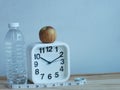 Photo of alarm clock with an apple,mineral water bottle and measure tape isolated on white background. Royalty Free Stock Photo