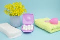A photo of alarm clock, menstrual pads, terry towel, tampons and menstrual cup for blood period. Menstruation period pain