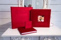 Photo album with a box on a wooden background. Photo book with embossing. photobook with a gift box Photo album with a