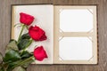 Photo album and roses on wood Royalty Free Stock Photo