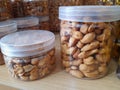 photo of almonds without skin that have been packed in jars of various sizes that are ready to be sold in the market