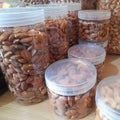 photo of almonds without skin that have been packed in jars of various sizes that are ready to be sold in the market