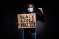 Photo of amazed afro american guy hold cardboard banner black lives banner raise fists celebrate discrimination stop