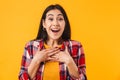 Photo of amazed brunette woman smiling while looking at camera