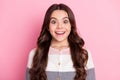 Photo of amazed charming excited young little girl good mood dream isolated on pastel pink color background