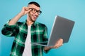 Photo of amazed excited happy man look hold hand laptop news good mood isolated on blue color background