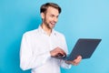 Photo of amazed happy cheerful young businessman look laptop news isolated on pastel blue color background