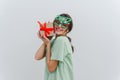 Photo of an amazed happy young woman with a smile hold a hand a Christmas gift isolated on a white background Royalty Free Stock Photo