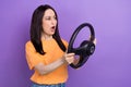 Photo of amazed mature funny woman learning how drive automobile vehicle surprised car accident isolated on purple color Royalty Free Stock Photo