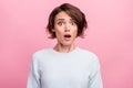 Photo of amazed shocked young woman afraid scared problem bad mood astonished isolated on pink color background