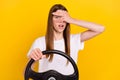 Photo of amazed young shocked unhappy woman peek eyes cover face steering wheel isolated on yellow color background