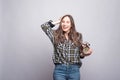 Photo of amazed young woman holding alarm clock Royalty Free Stock Photo