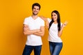 Photo of amazing couple working together best team showing v-sign symbol wear casual t-shirts and jeans isolated yellow Royalty Free Stock Photo