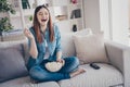 Photo of amazing lady watching favorite humorous tv show eating popcorn laughing out loud sitting comfy sofa wearing