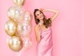 Smiling girl holds glass of champagne while stand near air balloons. came to party. Celebration Royalty Free Stock Photo