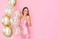 Amazing smiling girl holds glass of champagne and many air balloons. came to party. Celebration Royalty Free Stock Photo