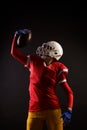 Photo of american female football player in helmet with ball raised up Royalty Free Stock Photo