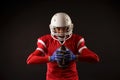 Photo of american female football player in helmet with rugby ball in hands Royalty Free Stock Photo