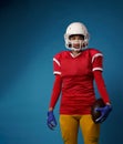 Photo of american female football player in white helmet, sportswear and ball in her hand Royalty Free Stock Photo