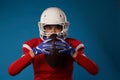 Photo of american female football player in white helmet, sportswear and ball in her hands Royalty Free Stock Photo