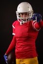 Photo of american woman football player in helmet with arm outstretched forward Royalty Free Stock Photo