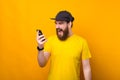 Photo of angry bearded man screaming at smartphone while talking with someone Royalty Free Stock Photo