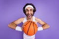 Photo of angry furious crazy young brunette man hold hands basketball scream wear glasses isolated on violet color Royalty Free Stock Photo