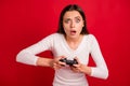 Photo of angry furious woman playing online games with her friend and losing obviously while isolated with red Royalty Free Stock Photo