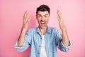 Photo of angry furious young man raise hands loud scream annoyed isolate pastel pink color background