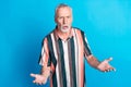 Photo of angry irritated senior man wear striped stylish clothes problem pretense isolated on blue color background