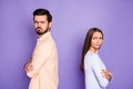 Photo of angry sad man and woman couple look each other stand back to back conflict folded hands isolated on purple Royalty Free Stock Photo