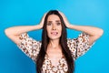 Photo of anxious embarrassed cute girl wear trendy print clothes arm touch head isolated on blue color background