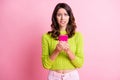 Photo of anxious scared girl hold telephone bite lip wear green sweater isolated pink color background