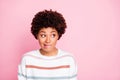 Photo of anxious thinking guessing black girl biting her lips staring away at empty space with misunderstanding face Royalty Free Stock Photo